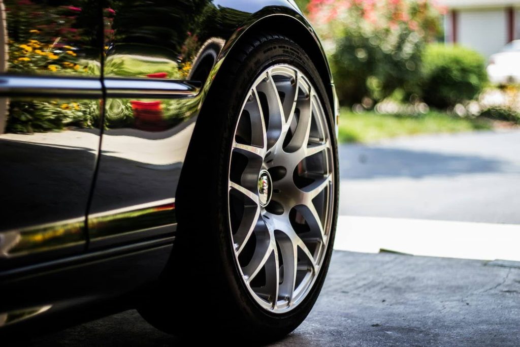 close up of a car from the front tyre in driveway